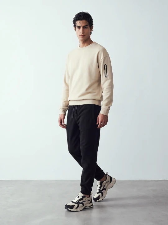 Zdjęcie produktu Sinsay - Bluza crewneck z kieszenią na rękawie - kremowy