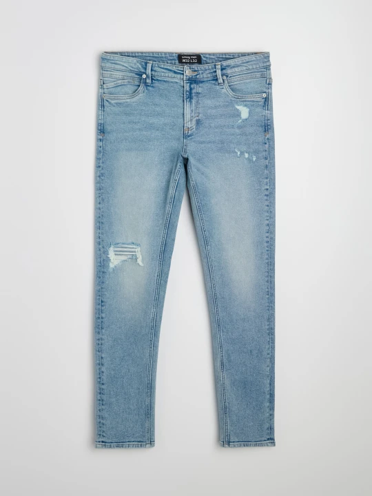 Zdjęcie produktu Sinsay - Jeansy slim fit z przetarciami i efektem sprania - niebieski