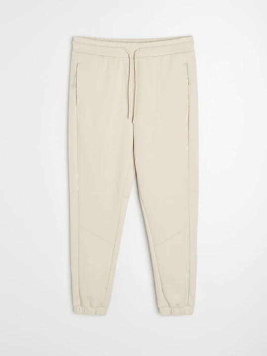 Zdjęcie produktu Sinsay - Spodnie tapered fit Active - kremowy
