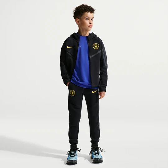 Zdjęcie produktu Spodnie do piłki nożnej dla dużych dzieci (chłopców) Nike Chelsea F.C. Tech Fleece - Niebieski