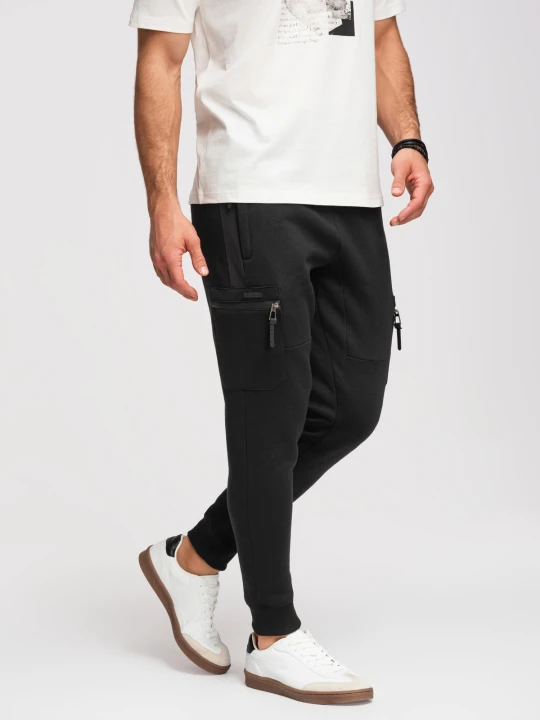 Zdjęcie produktu Spodnie dresowe męskie JOGGER z kieszeniami na udach i kontrastującymi wstawkami - czarne V1 - Rozmiar: S Ombre Clothing