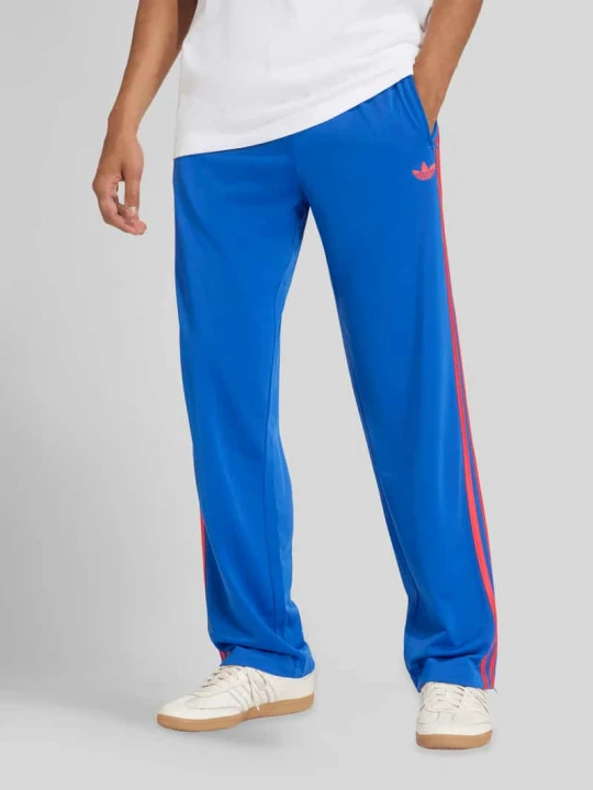 Zdjęcie produktu Spodnie dresowe o kroju regular fit z detalami z logo adidas Originals Królewski niebieski
