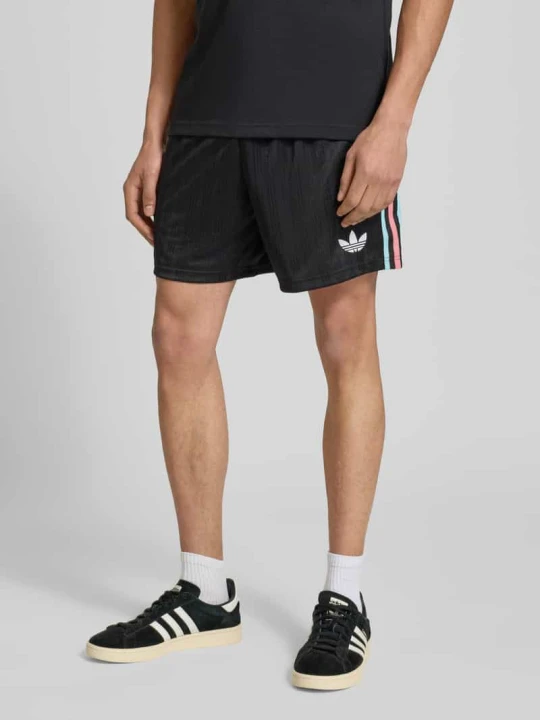 Zdjęcie produktu Spodnie dresowe o kroju regular fit z detalem z logo model 'Belgien 26' adidas Originals Czarny