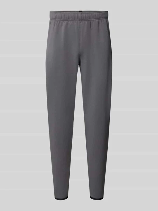 Zdjęcie produktu Spodnie dresowe o kroju regular fit z dodatkiem bawełny model 'Unstoppable' Under Armour Antracytowy