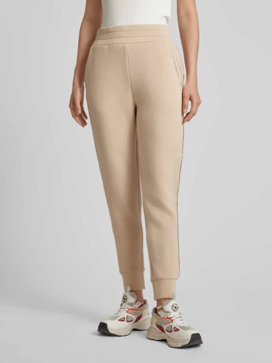 Zdjęcie produktu Spodnie dresowe o kroju regular fit z lampasami model ‘SIMONNE’ Guess Piaskowy