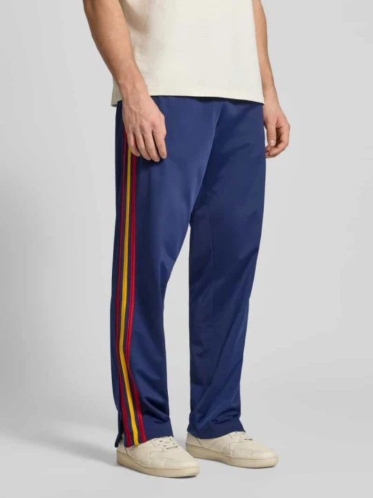 Zdjęcie produktu Spodnie dresowe w kroju regular fit z kontrastowymi lampasami model 'FIREBIRD' adidas Originals Ciemnoniebieski