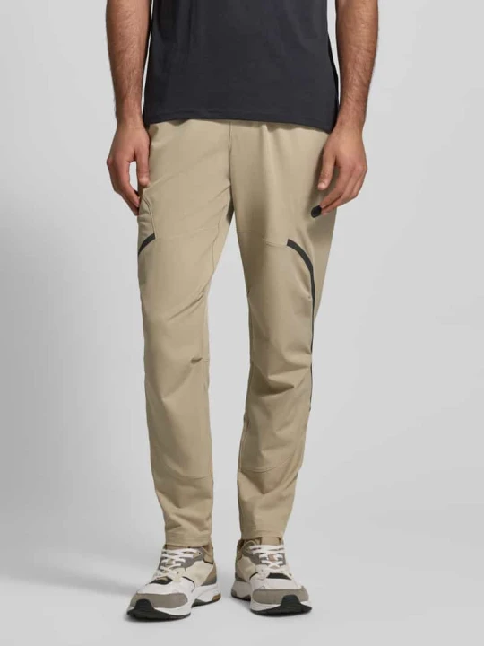Zdjęcie produktu Spodnie dresowe o kroju regular fit z nadrukiem z logo Model 'Unstoppable' Under Armour Khaki