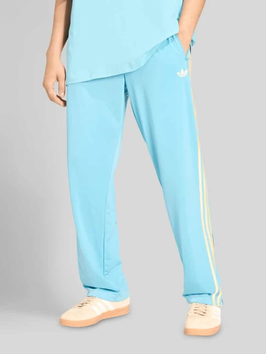 Zdjęcie produktu Spodnie dresowe o kroju relaxed fit model 'FIREBIRD' adidas Originals Turkusowy