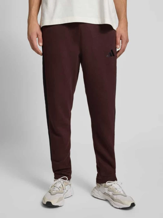 Zdjęcie produktu Spodnie dresowe o kroju slim fit z dodatkiem wiskozy model ‘SHAB’ Adidas Ciemnobrązowy
