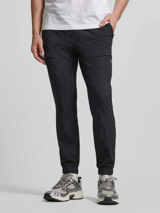 Zdjęcie produktu Spodnie dresowe o kroju slim fit z nadrukiem z logo Fabletics Czarny