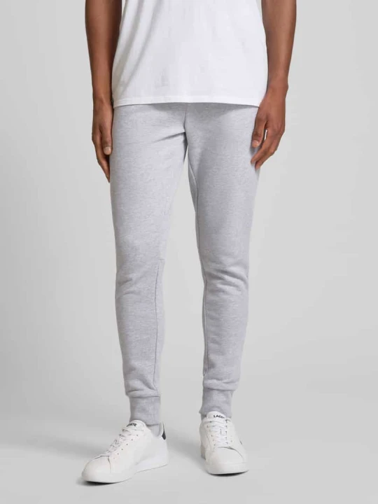 Zdjęcie produktu Spodnie dresowe o kroju slim fit z naszywką z logo Lacoste Jasnoszary