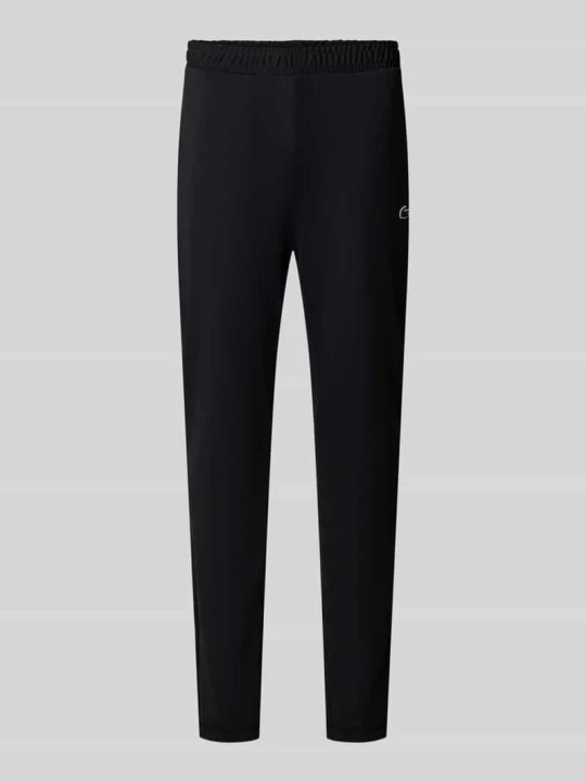 Zdjęcie produktu Spodnie dresowe o kroju slim fit z naszywką z logo Lacoste Czarny