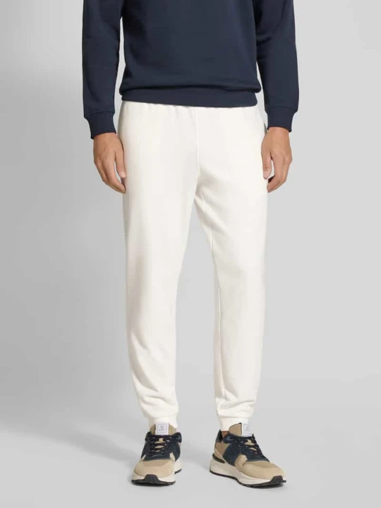 Zdjęcie produktu Spodnie dresowe o kroju tapered z czystej bawełny Lacoste Złamany biały