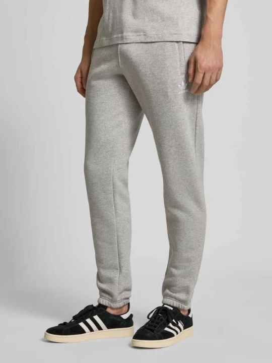 Zdjęcie produktu Spodnie dresowe z elastycznym pasem i wpuszczanymi kieszeniami adidas Originals Jasnoszary melanż