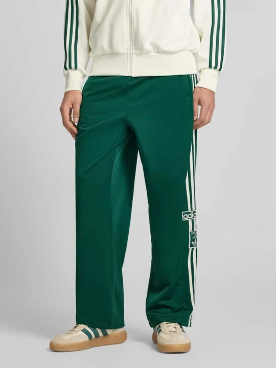 Zdjęcie produktu spodnie dresowe z elastycznym pasem model "ADIBREAK" adidas Originals Ciemnozielony