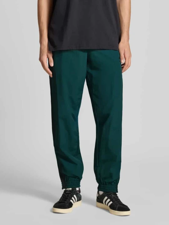 Zdjęcie produktu Spodnie dresowe z elastycznym ściągaczem adidas Originals Ciemnozielony