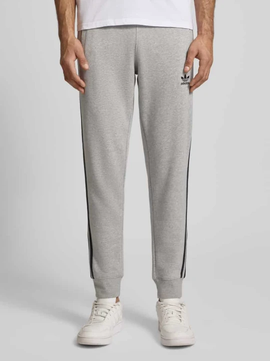 Zdjęcie produktu Spodnie dresowe z elastycznym ściągaczem adidas Originals Średnioszary melanż