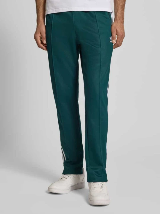 Zdjęcie produktu Spodnie dresowe z elastycznym ściągaczem adidas Originals Ciemnozielony