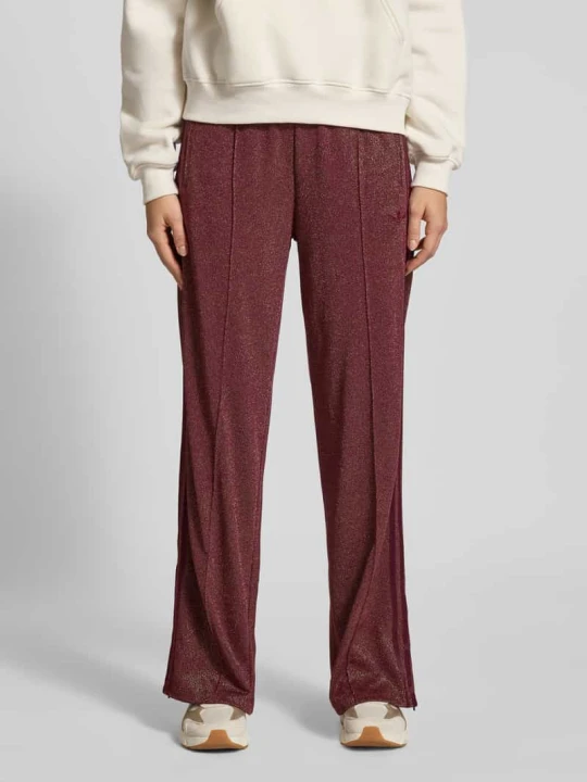 Zdjęcie produktu Spodnie dresowe z elastycznym pasem model "LUREX® FIREBIRD" adidas Originals Bordowy