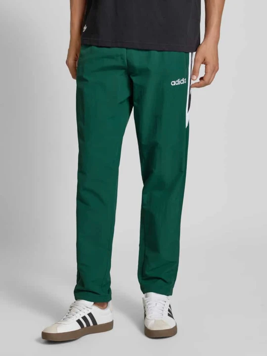 Zdjęcie produktu Spodnie dresowe z elastycznym ściągaczem adidas Originals Ciemnozielony