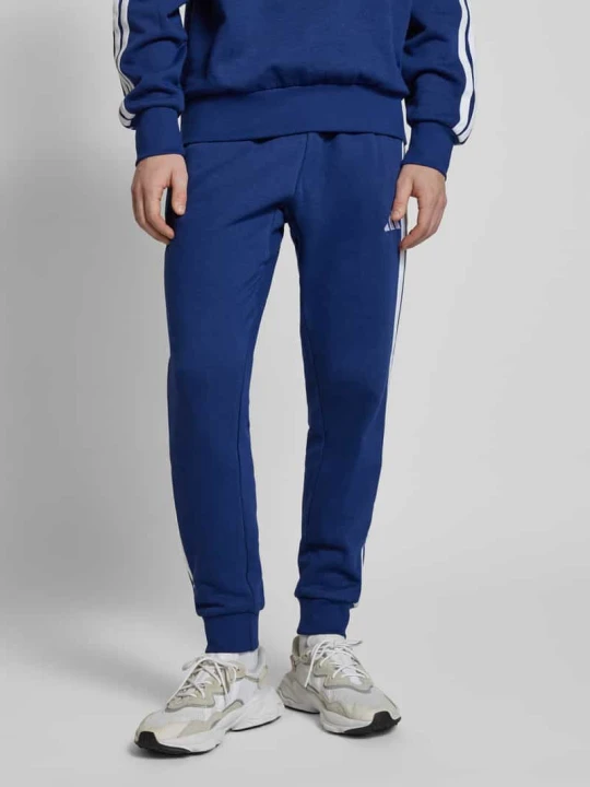 Zdjęcie produktu Spodnie dresowe z elastycznym ściągaczem Adidas Granatowy