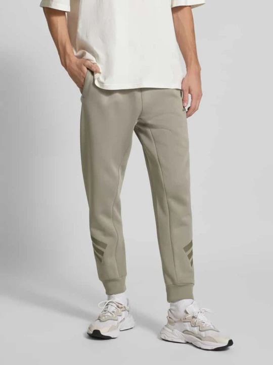 Zdjęcie produktu Spodnie dresowe z elastycznym ściągaczem Adidas Trzcinowy
