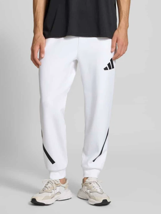 Zdjęcie produktu Spodnie dresowe z elastycznym ściągaczem Adidas Biały