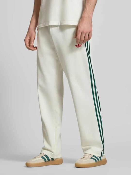 Zdjęcie produktu Spodnie dresowe z kieszeniami na zamek i haftowanym logo adidas Originals Złamany biały