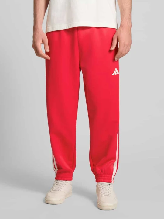 Zdjęcie produktu Spodnie dresowe z logo i elastycznym pasem Adidas Czerwony