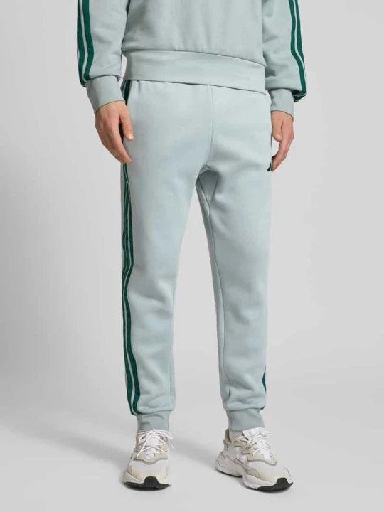Zdjęcie produktu Spodnie dresowe z logo i elastycznym pasem Adidas Miętowy