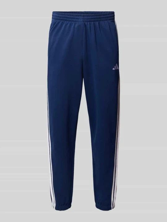 Zdjęcie produktu Spodnie dresowe z paskami w kontrastowym kolorze Adidas