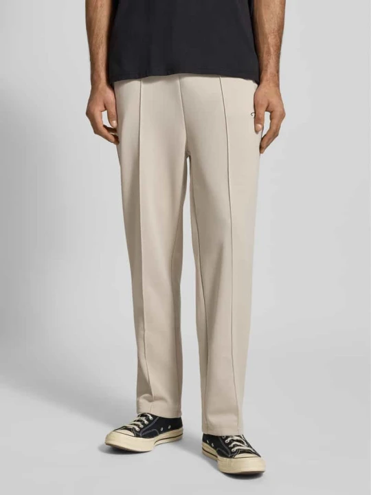 Zdjęcie produktu Spodnie dresowe z wyhaftowanym logo model ‘Motus Track Pants’ Pegador Écru