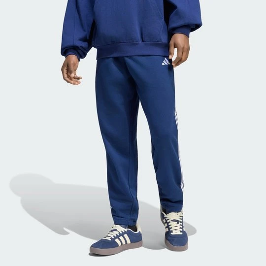 Zdjęcie produktu Spodnie Essentials z tkaniny frotté z 3 paskami i zwężanymi nogawkami Adidas