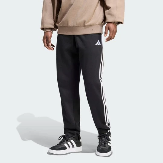 Zdjęcie produktu Spodnie Essentials z tkaniny frotté z 3 paskami i zwężanymi nogawkami Adidas