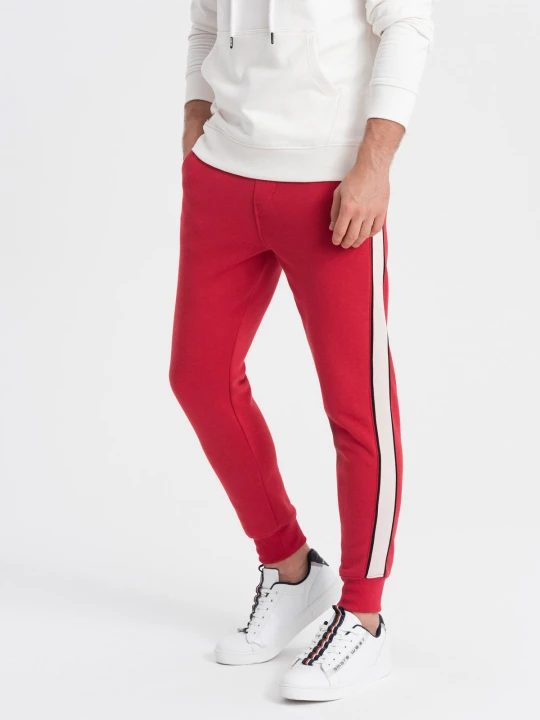 Zdjęcie produktu Spodnie męskie dresowe z lampasem - czerwone V4 - Rozmiar: M Ombre Clothing
