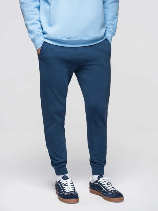 Zdjęcie produktu Spodnie męskie dresowe ze ściągaczem przy nogawce BASIC jogger - granatowe V4 - Rozmiar: M Ombre Clothing niebieski