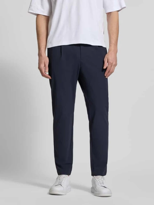 Zdjęcie produktu Spodnie w kroju slim fit z kieszeniami z lamówką na pośladkach CRUNA Ciemnoniebieski