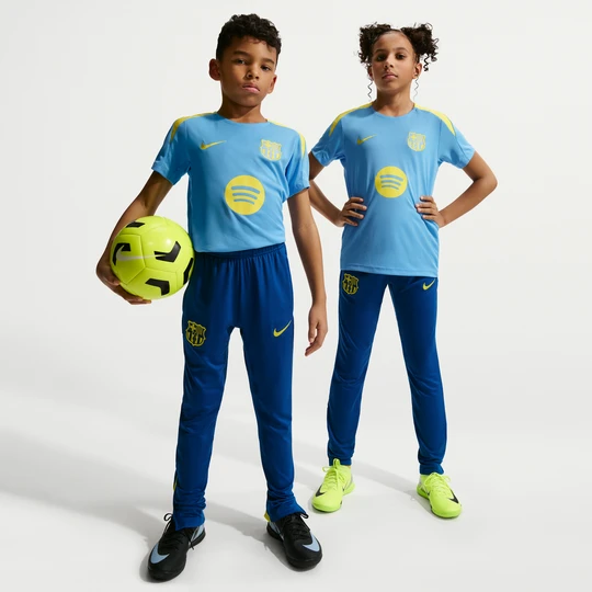 Zdjęcie produktu Spodnie piłkarskie z dzianiny dla dużych dzieci Nike Dri-FIT FC Barcelona Strike (wersja czwarta) - Niebieski