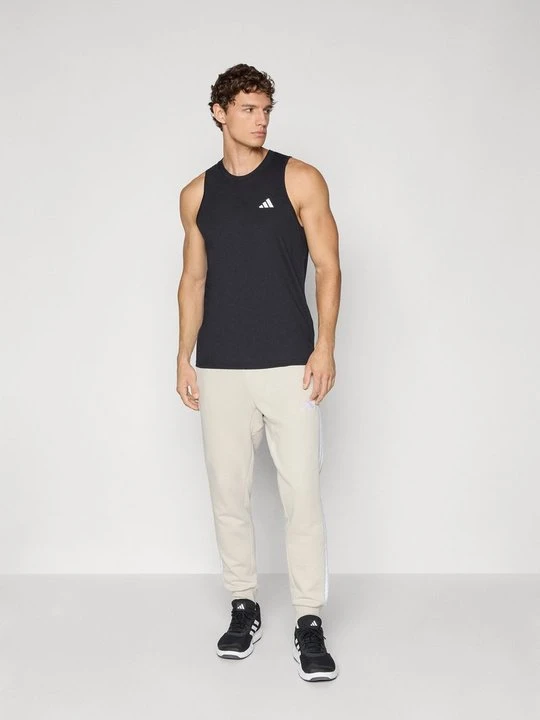 Zdjęcie produktu Spodnie treningowe Adidas mleczny
