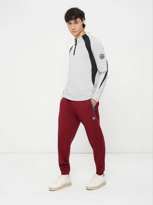 Zdjęcie produktu Spodnie treningowe EA7 Emporio Armani ciemnoczerwony