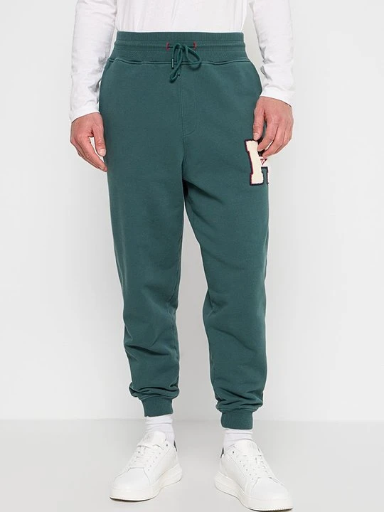 Zdjęcie produktu Spodnie treningowe Tommy Jeans zieleń butelkowa
