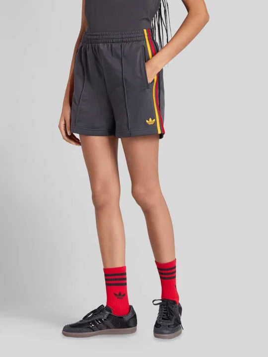 Zdjęcie produktu Spodnie treningowe z elastycznym pasem adidas Originals Antracytowy