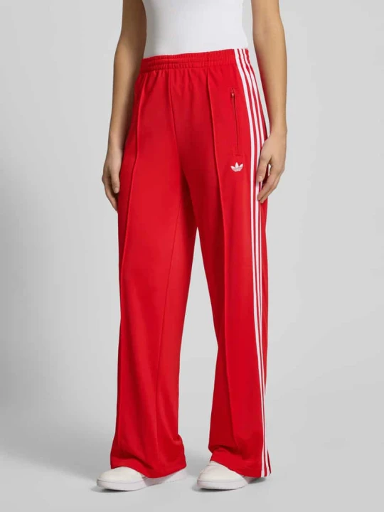 Zdjęcie produktu Spodnie treningowe z elastycznym pasem i logo model ‘FIREBIRD’ adidas Originals Czerwony