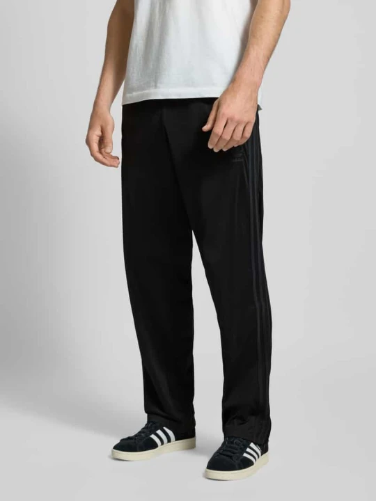 Zdjęcie produktu Spodnie treningowe z elastycznym pasem Model 'FIREBIRD' adidas Originals Czarny