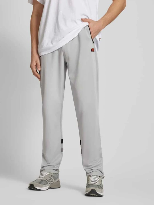 Zdjęcie produktu Spodnie typu track pants o kroju regular fit z naszywką z logo model ‘PALMINTERI’ Ellesse Jasnoszary