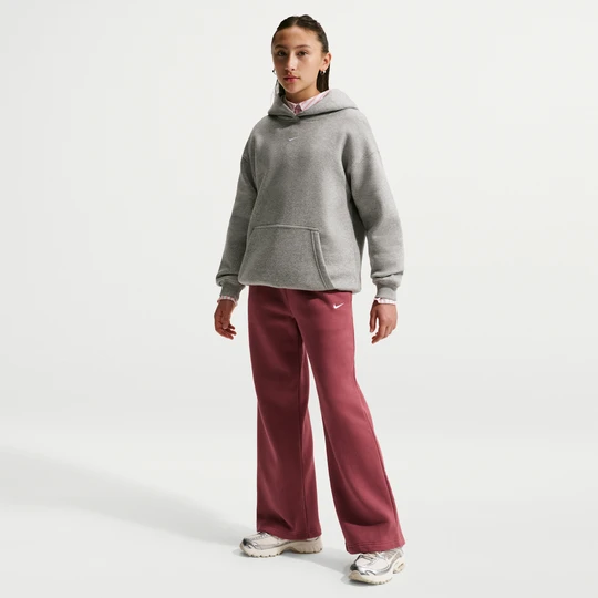 Zdjęcie produktu Spodnie z otwartym dołem dla dziewcząt Nike Studio Fleece - Czerwony