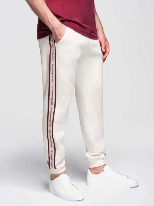 Zdjęcie produktu Sportowe spodnie męskie jogger z lampasami – kremowe V2 - Rozmiar: XXL Ombre Clothing kremowy