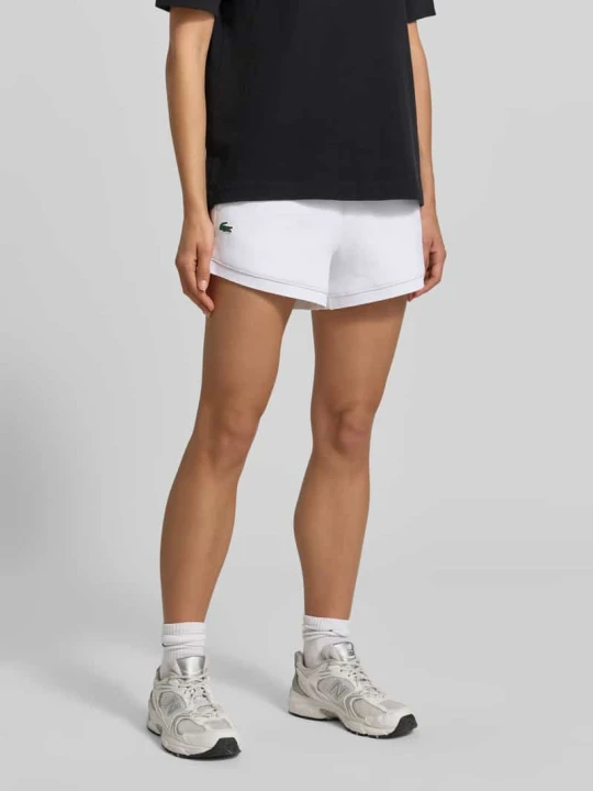 Zdjęcie produktu Szorty dresowe w kroju regular fit z aplikacją z logo Lacoste Biały