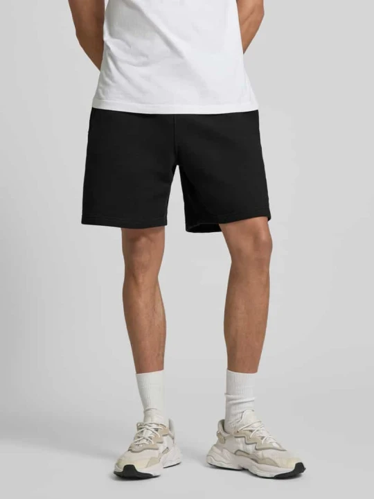 Zdjęcie produktu Szorty dresowe z mieszanki bawełny w kroju regular fit model 'TREFOIL ESSENTIALS' adidas Originals Czarny