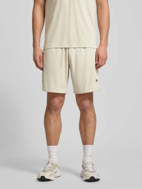 Zdjęcie produktu Szorty o kroju regular fit z napisem z logo model "TOC SPIN 9 INCH" Boss Beżowy